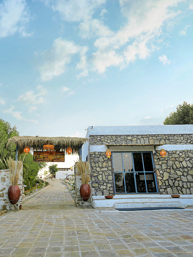 Charming stone resort entrance with peaceful desert pathway