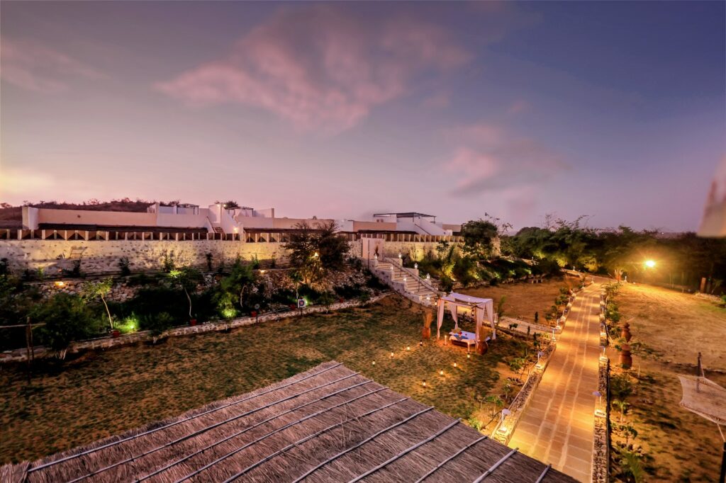 Luxury desert retreat illuminated at twilight with pathways