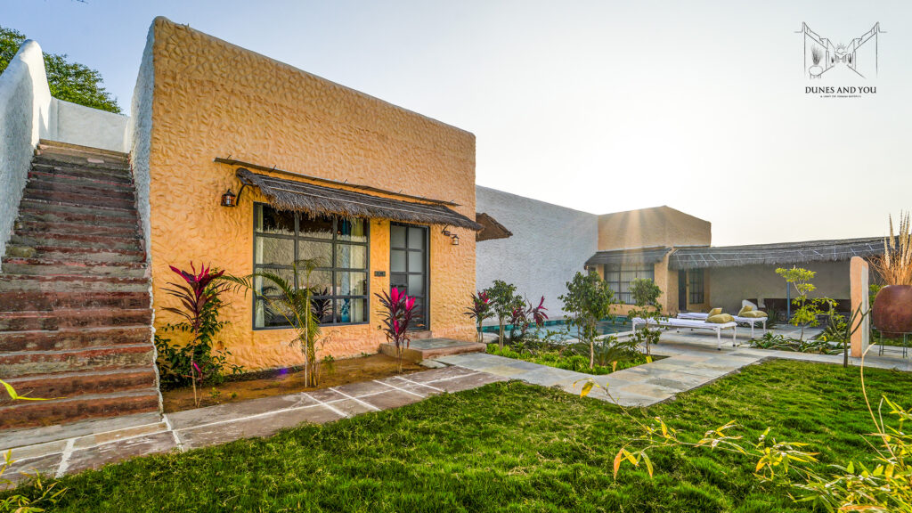 Luxury desert retreat illuminated at twilight with pathways